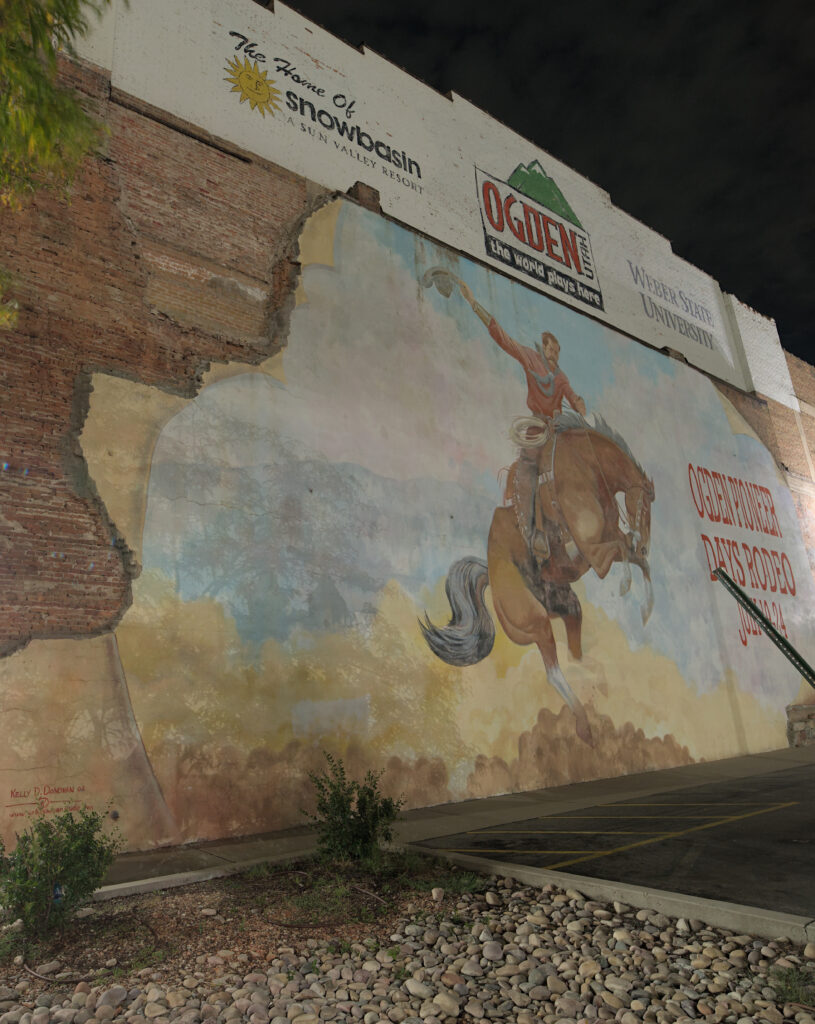 Wall painting of a man getting bucked by a horse. Text on the image is for "Pioneer Days Rodeo".